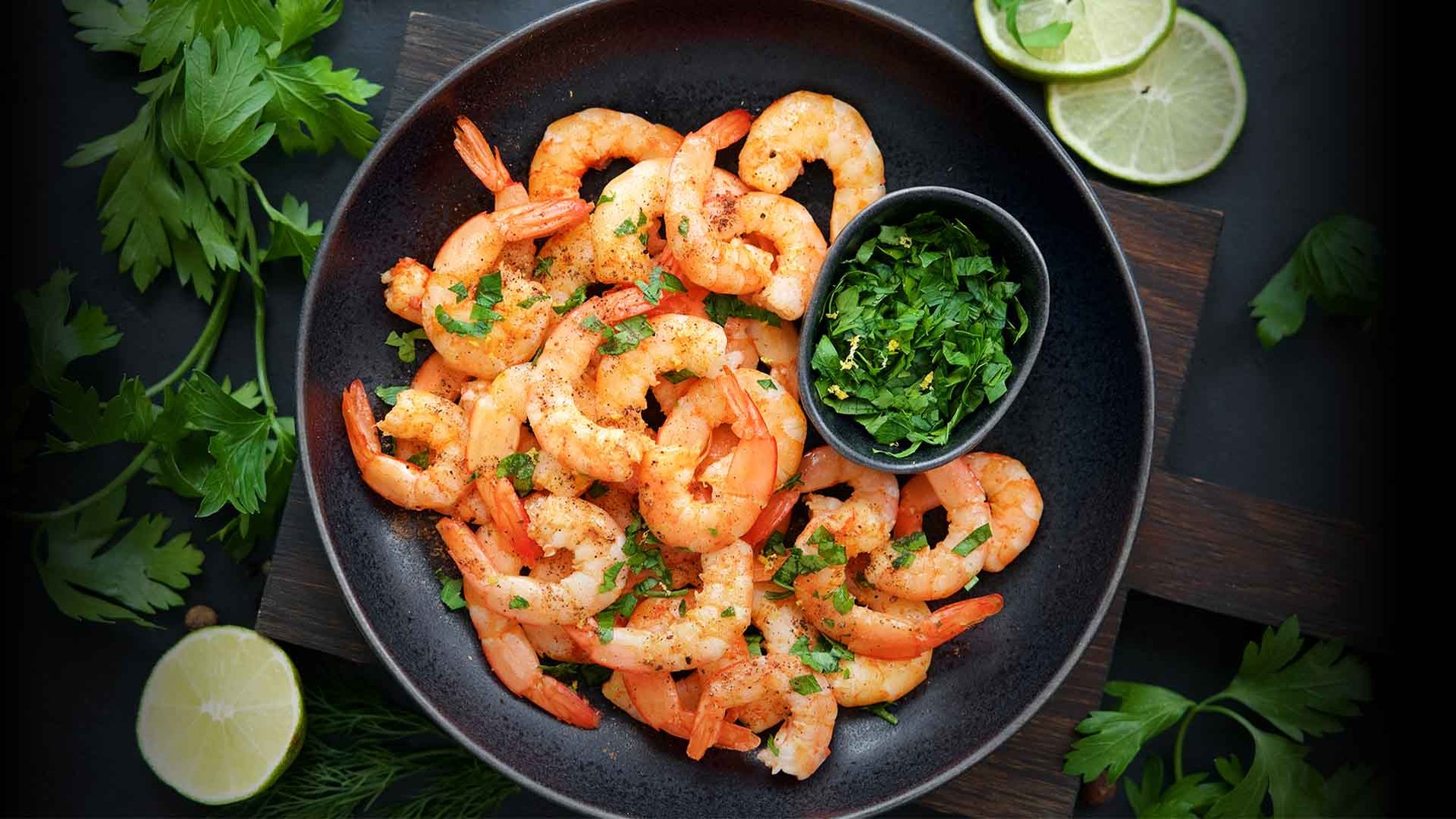 A skillet of cooked shrimp.