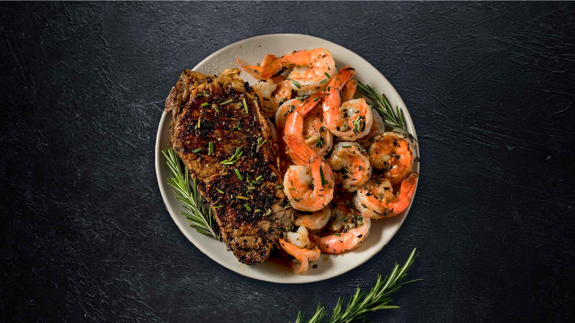 A delicious plated steak and shrimp image.