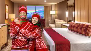 Photo collage of young couple in winter sweaters and hats in front of a Vista Deluxe King Rooom at Grand Sierra Resort in Reno, NV.