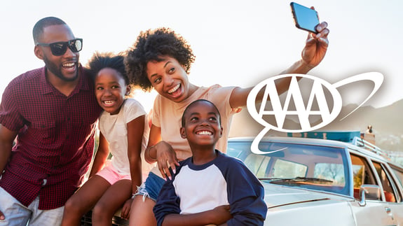 Traveling family taking selfie with AAA logo.