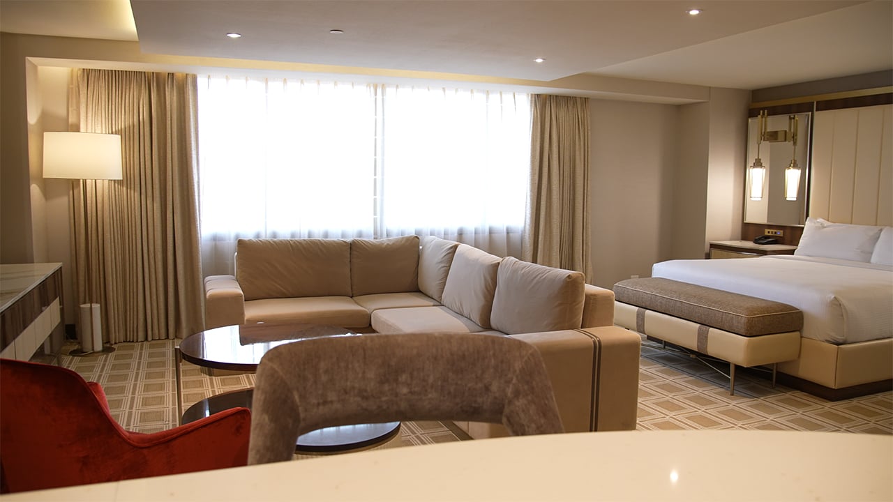 A hotel suite with a living area and bedroom