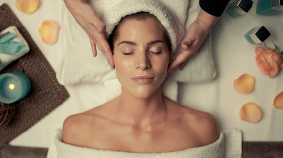 Female client receiving face massage at The Spa.
