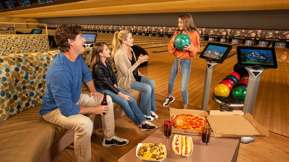 Family having fun and snacks in GSR Bowling Center.