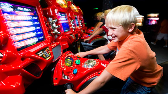 Child having fun on arcade ride at Fun Quest. 