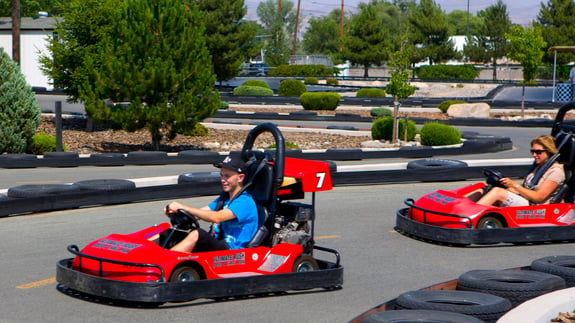 Racing go-karts on speed track. 